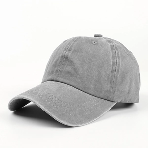 Detail view of grey washed cotton baseball cap featuring vintage distressed texture and curved brim