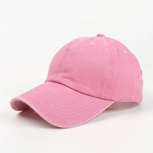 Close-up of pink washed cotton baseball cap showing detailed fabric texture and stitching
