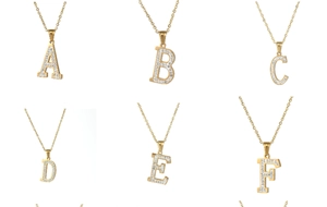 Detailed grid view of 18k gold plated letter pendants A to F with pavé zircon crystals