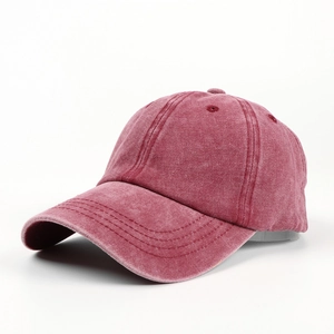 Close-up of vintage washed burgundy cotton baseball cap showing distressed fabric texture