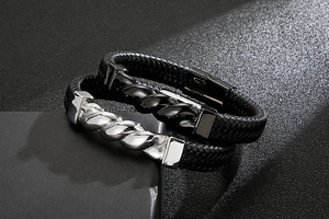 Macro detail of men's braided leather bracelets with twisted metal ornaments and magnetic clasp