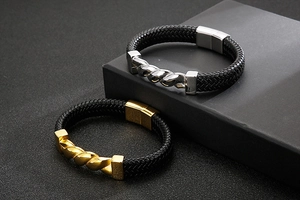 Detail of woven leather bracelets with twisted gold and silver magnetic metal buckles