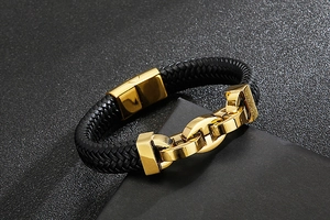 Detailed view of black braided leather men's bracelet with double golden steel clasps