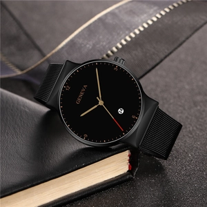 Macro detail of men's black alloy watch dial with gold markers and red second hand
