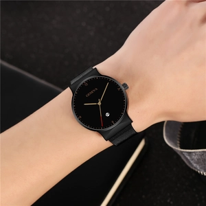 Close-up of Geneva minimalist black quartz watch with mesh strap on male wrist