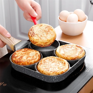 Macro shot of 4-hole non-stick maifan stone frying pan with eggs and wood-grain handle