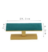 Detail view of emerald green velvet jewelry display stand with bamboo wood base 20.3cm