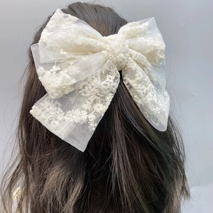 Detailed back view of a large double-layer off-white lace bow hair clip with floral embroidery
