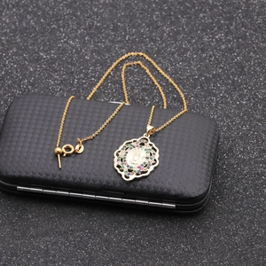 Golden Virgin Mary oval pendant necklace with multicolored gemstones on black background