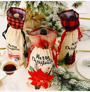 Three burlap Christmas wine bottle bags with plaid accents and poinsettia detail