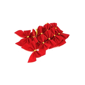 Detail of red velvet Christmas bows with gold twist ties for DIY holiday decorations