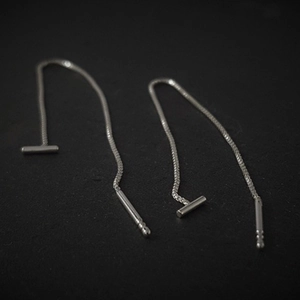 Elegant silver T-bar tassel drop earrings with long chain dangles on a black background