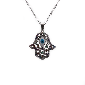 Silver Hamsa Hand necklace with blue Evil Eye and colorful gemstones on white background