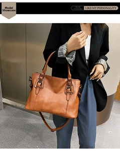 Brown faux leather tote bag with dual handles, detachable strap and metal buckle detail