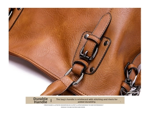 Detail of brown leather handle with metallic buckle and reinforced stitching