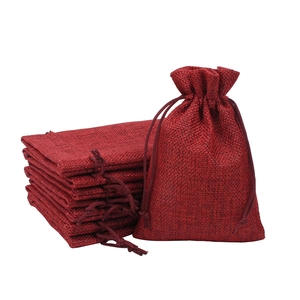 Red Christmas drawstring burlap gift bags set with linen texture on white background