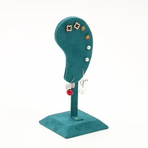 Dark green velvet ear-shaped earring display stand with a stable square base for jewelry stores