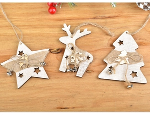 Wooden Christmas hanging ornaments detail shot showing star, deer and tree design with rustic rope.