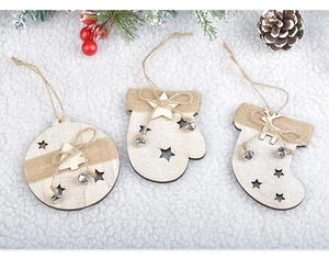 Close-up of wooden Christmas tree hanging ornaments with bells, stars and jute rope details.