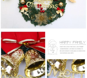 Detailed view of Christmas wreath featuring golden Merry Christmas sign and red bow decor