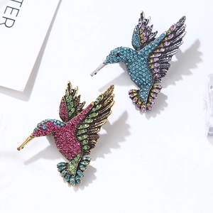 Vintage hummingbird brooches with vibrant crystals in silver and gold-tone settings