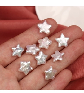 Macro shot of nine star-shaped natural freshwater pearls held in palm for DIY jewelry making