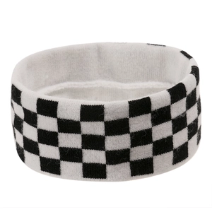 Detail of checkered black and white knitted headband showing elastic wool texture