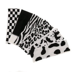 Detailed set of 6 knitted headbands with diverse black and white patterns on white background