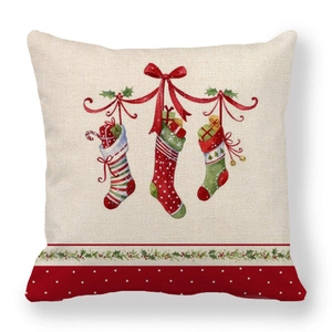 Close-up of linen cushion cover showing three Christmas stockings and festive red bows