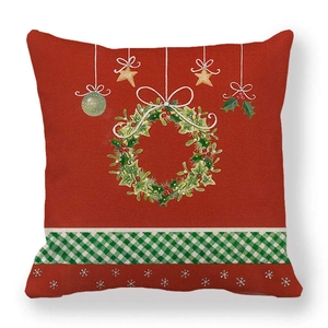 Detail of linen Christmas pillowcase featuring a festive wreath and green plaid pattern