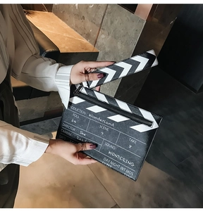 Macro shot of stylish clapperboard crossbody bag with printed film production details