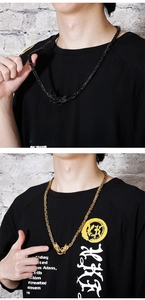 Detail of square woven chains with dragon head clasps in black and gold finishes