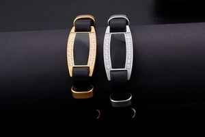 Detail view of gold and silver stainless steel leather bracelets with cubic zirconia accents