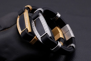 Detailed macro view of the gold and silver steel plating with inlaid zircons on black band