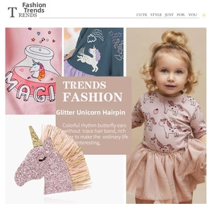 Close-up of glittery unicorn hair clip with pink sequins and fringe on a child model