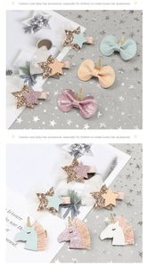 Detail of unicorn hair clip and sequin star bow accessory for kids on star pattern fabric