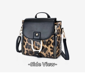 Detailed side view of leopard print shoulder bag with gold buckle and black flap
