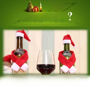 Close-up of festive Christmas wine bottle decoration featuring mini red hat and scarf set