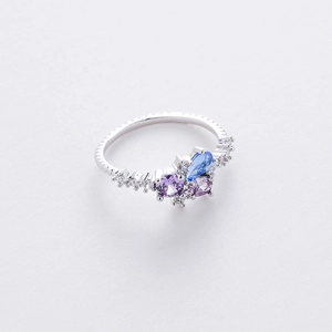 Detail of flower-shaped ring with blue pear-cut and purple zircon stones in silver