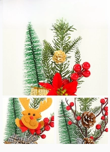 Detail display of mini Christmas tree with red berries, pine cones, and a felt reindeer