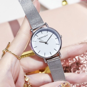 Minimalist women's quartz watch with silver Milanese mesh band on a pink background