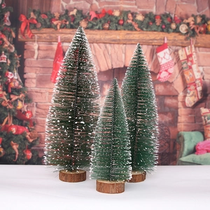 Three-piece mini cedar Christmas trees with snow dusting and rustic wood bases
