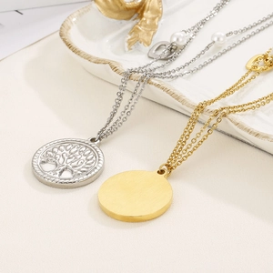 Minimalist double layer tree of life necklace set in silver and gold finish on ceramic plate
