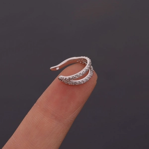 Macro shot of silver U-shaped ear cuff with multi-layer rows of sparkling cubic zirconia