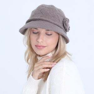 Close-up of grey knitted bucket hat with elegant flower detail and warm wool texture