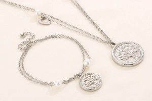 Detailed view of silver tree of life double necklace and matching pearl bracelet set