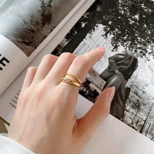 Close-up of double-layered gold ring with a polished finish worn on the index finger
