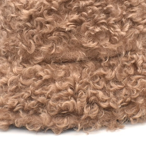 Close-up of thick winter lambswool fabric showing curly brown plush texture on warm bucket hat