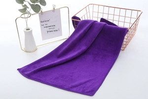 Macro view of thick purple microfiber car towel texture inside a rose gold wire basket