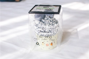 Plush coral fleece cake socks in a transparent gift box with a soft cupcake fold design